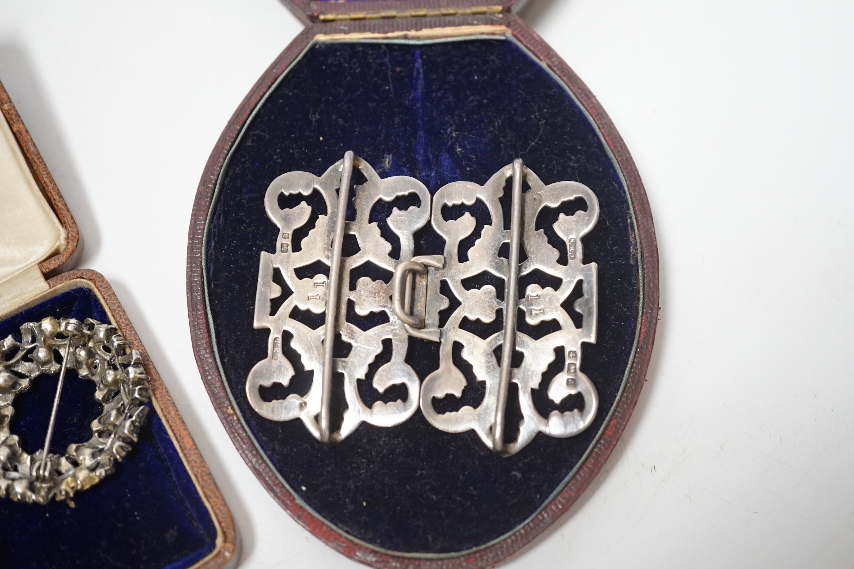 A late Victorian silver belt buckle, Birmingham, 1900, 72mm, three shagreen mounted cigarette holders and two costume brooches.